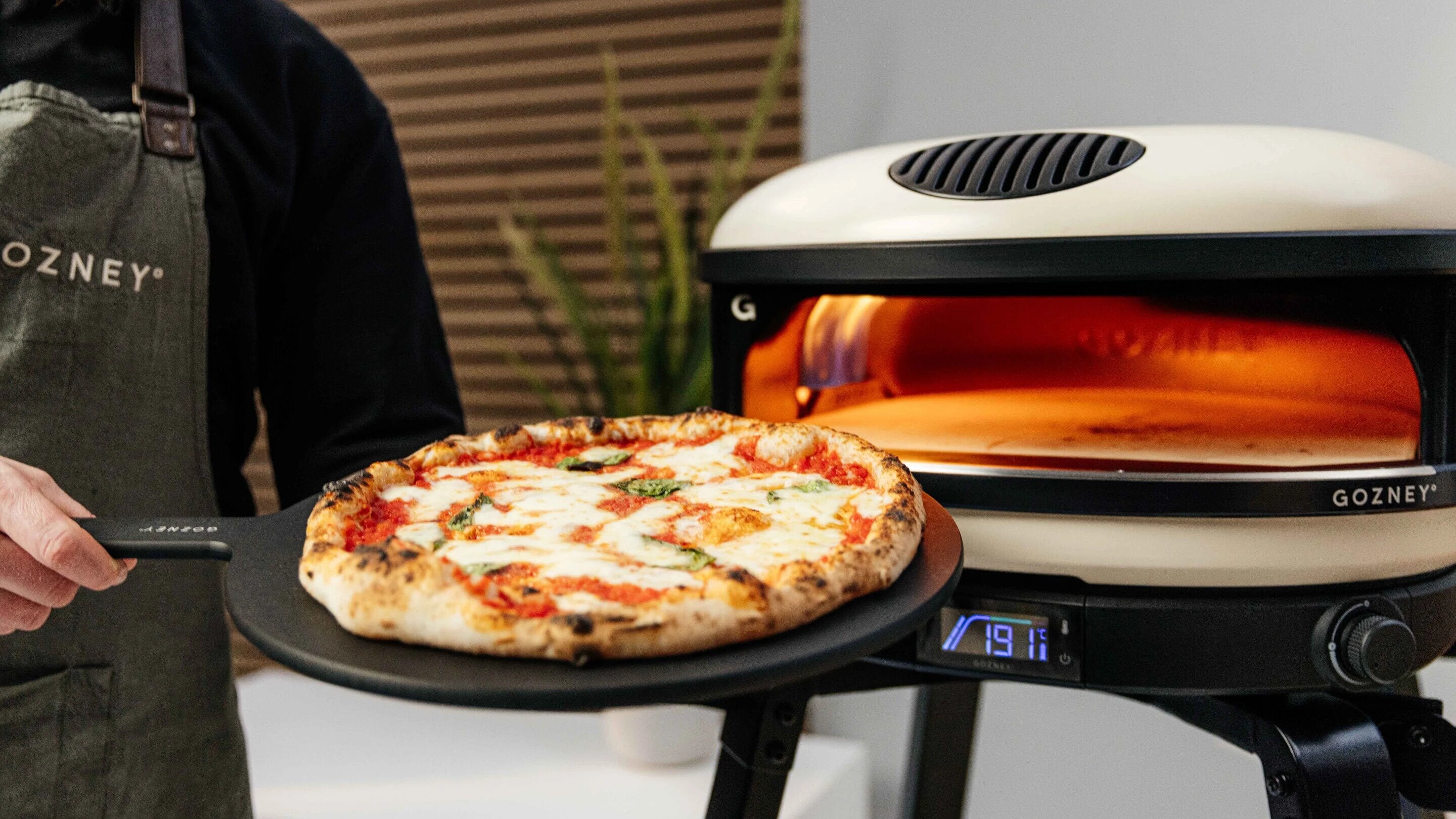 Puling Cooked Pizza Out Of The Gozney Arc XL Pizza Oven - Lifestyle Image