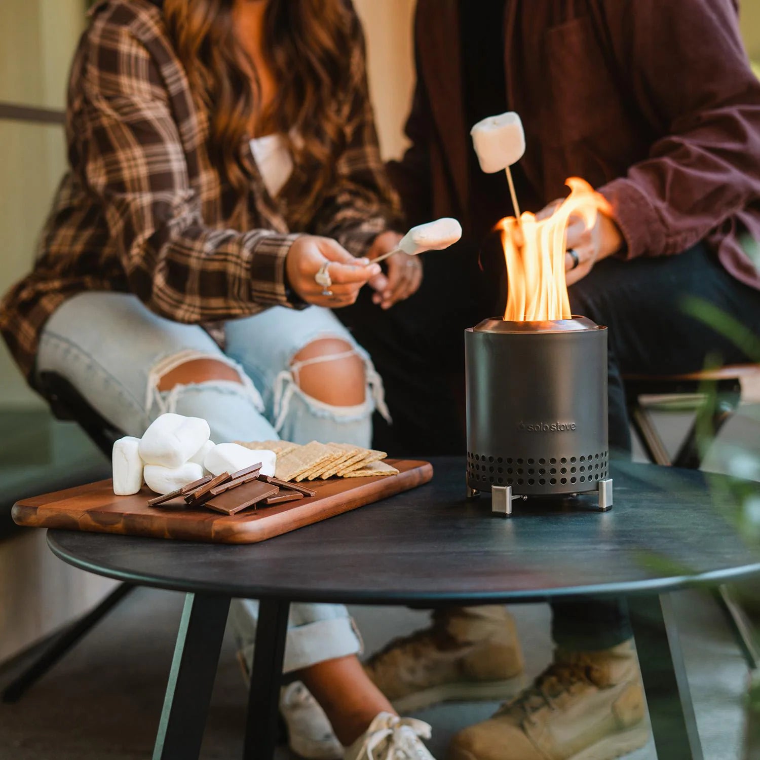 Couple Making Smores on the Solo Stove Tabletop Mesa Fire Pit - Lifestyle Image