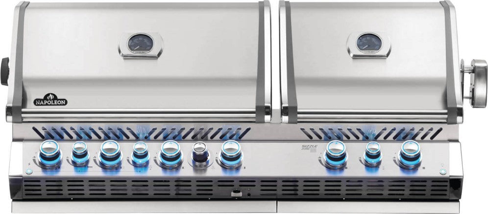 A built-in Napoleon Prestige Pro 825 gas grill with dual grill heads, stainless steel construction, and blue flame patterns for an outdoor kitchen.