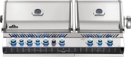 A built-in Napoleon Prestige Pro 825 gas grill with dual grill heads, stainless steel construction, and blue flame patterns for an outdoor kitchen.