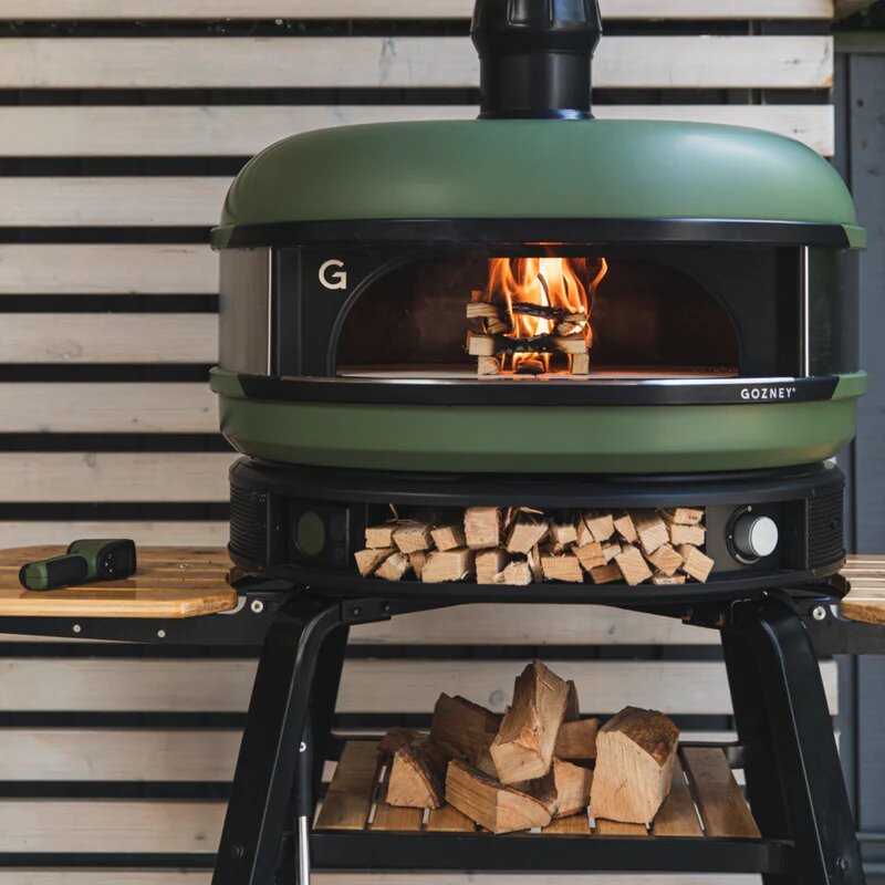 Gozney Green Multi Fuel Dome Pizza Oven On Gozney Pizza Stand - Lifestyle Image