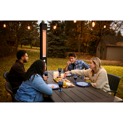 People sitting around an outdoor table with a Napoleon Phantom Infrared Electric Heater in the background.
