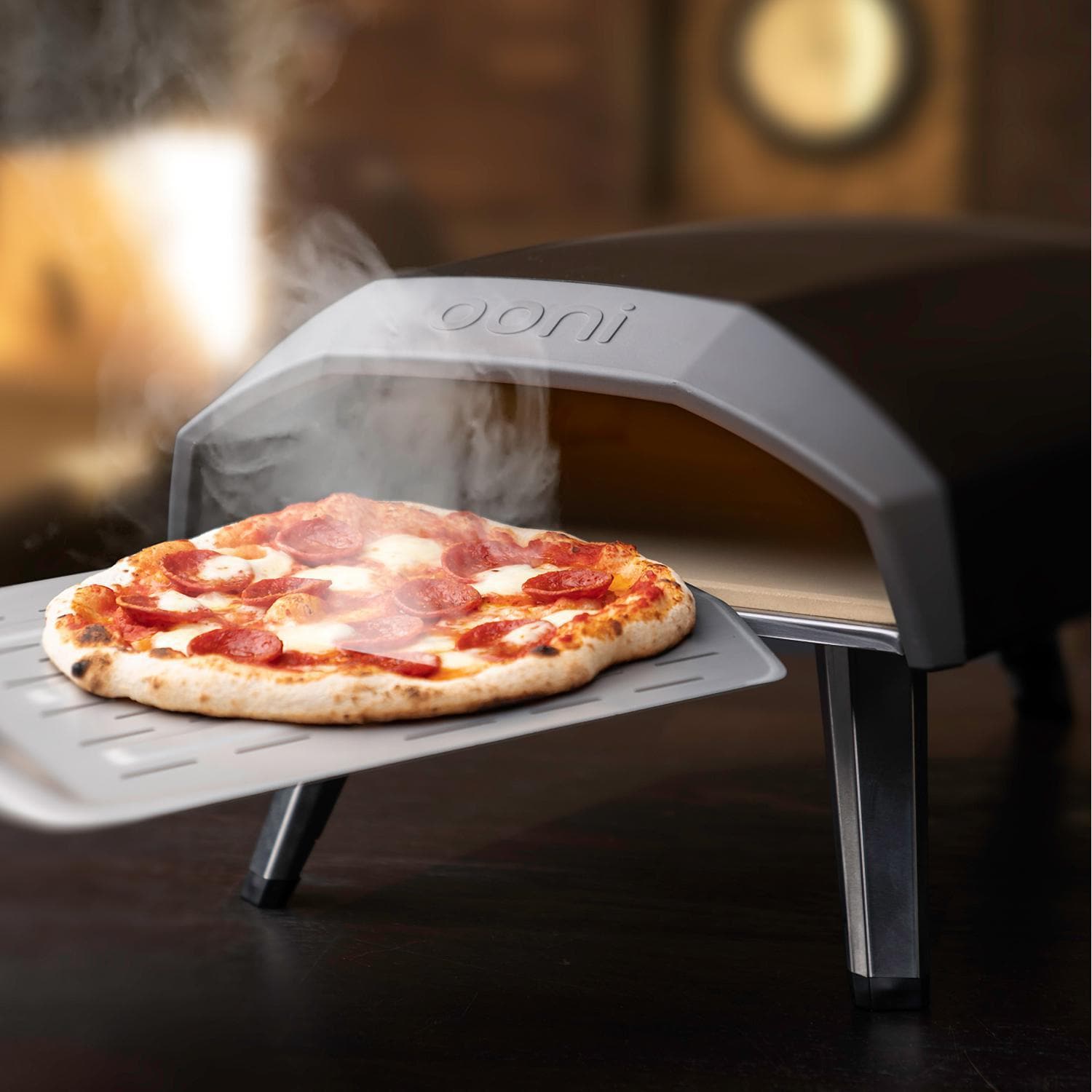 Pulling pizza out of the Ooni Koda 12 Portable Pizza Oven