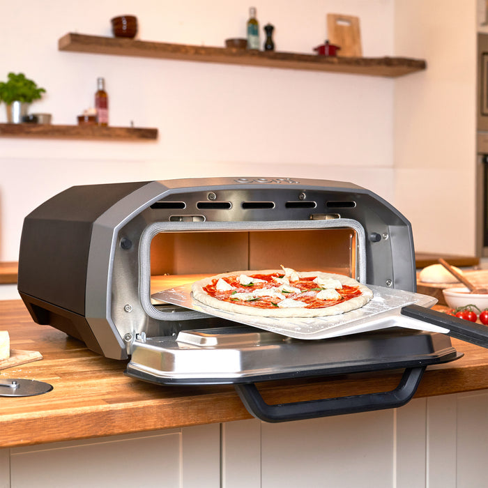 Pulling Pizza out of the Ooni Volt Electric Pizza Oven