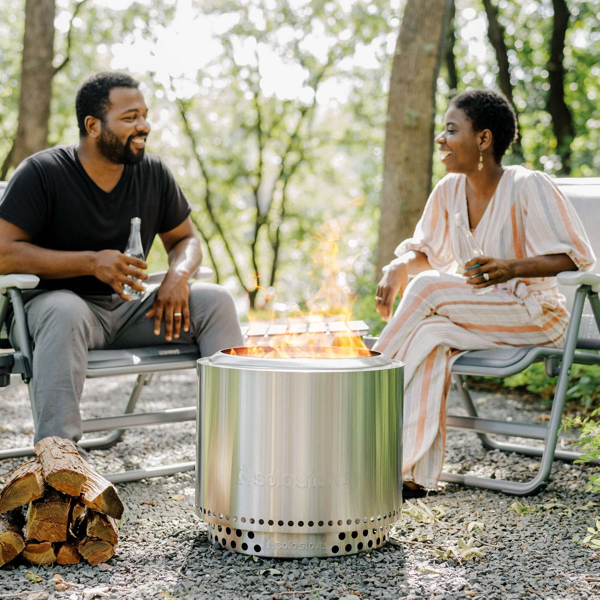 Man and woman sitting next to the Solo stove bonfire fire pit